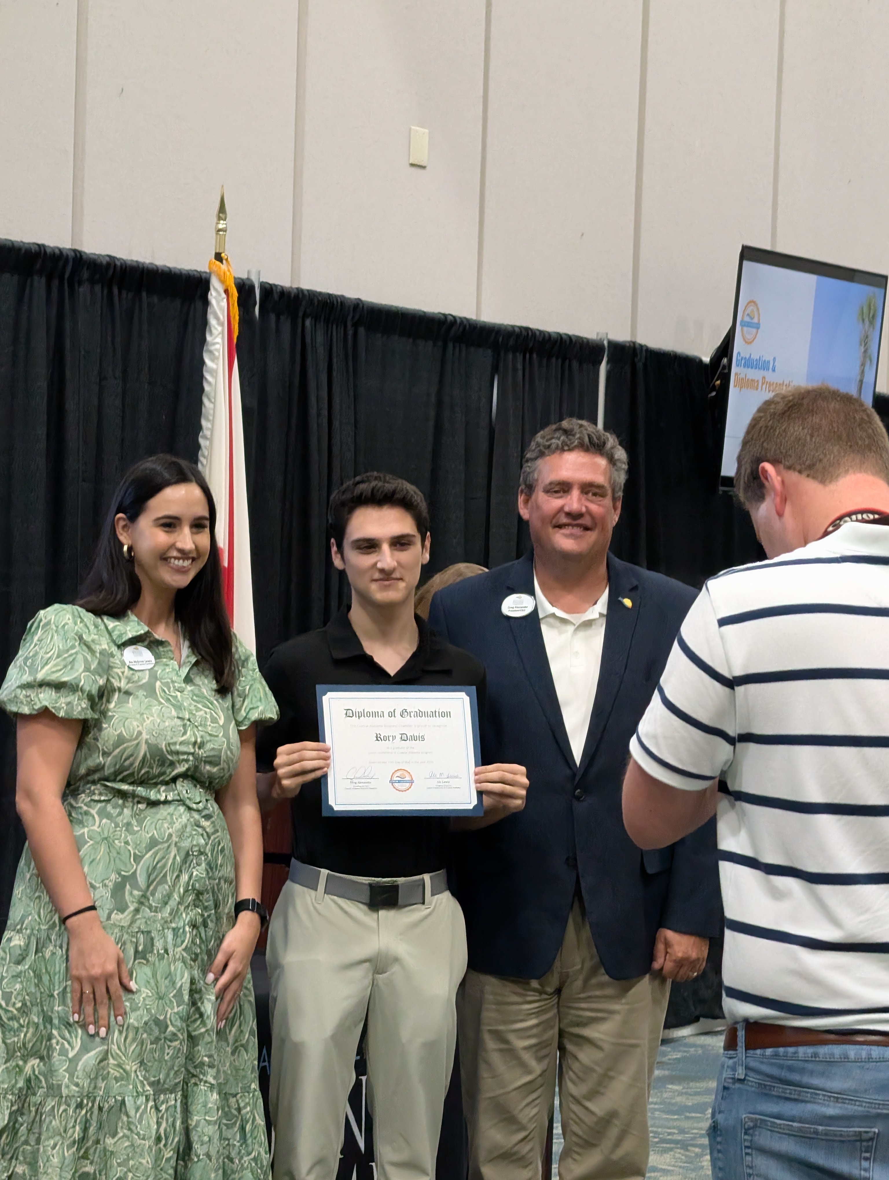 Student graduation diploma presentation at Coastal Alabama Chamber