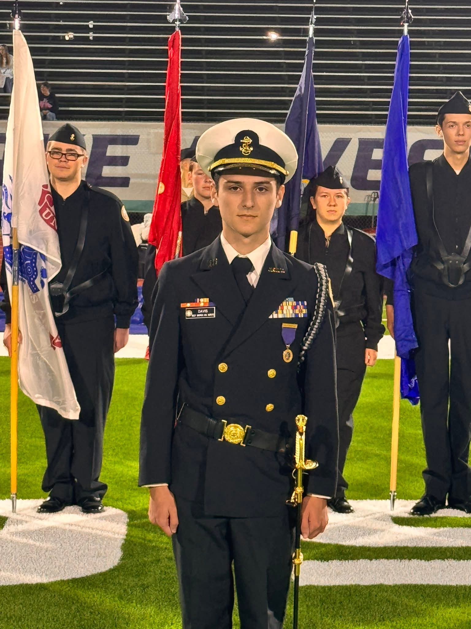Formal portrait of student in dark navy NJROTC dress uniform